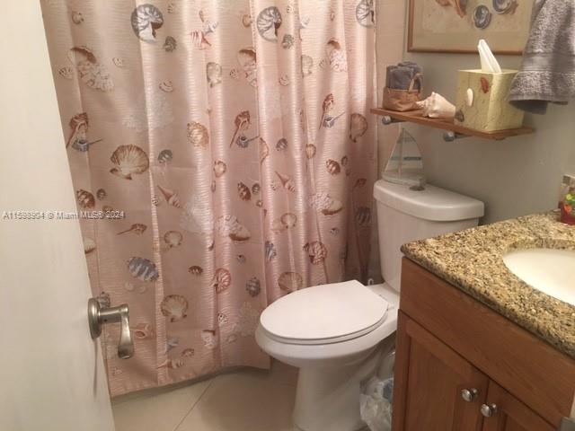 6783 Bridlewood Court, Unit 6783 Boca Raton, FL 33433 - Photo 26 of 56 a bathroom with a granite countertop toilet and a sink