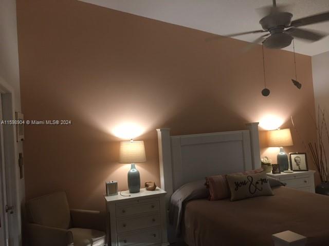 6783 Bridlewood Court, Unit 6783 Boca Raton, FL 33433 - Photo 27 of 56 a bedroom with a bed and a lamp