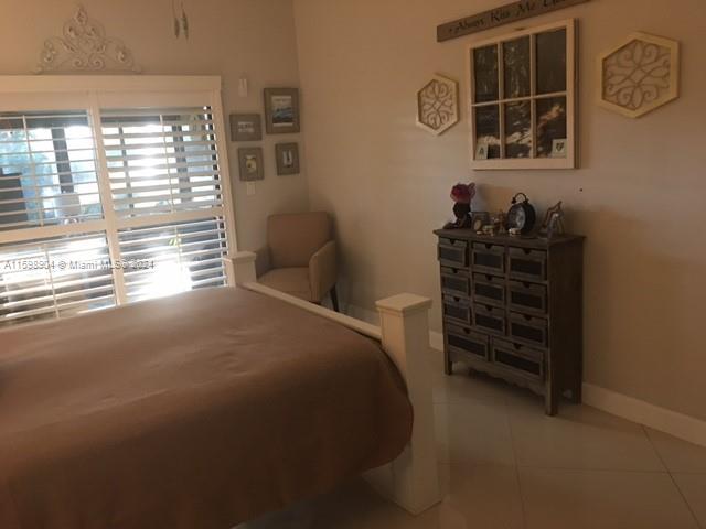6783 Bridlewood Court, Unit 6783 Boca Raton, FL 33433 - Photo 29 of 56 a view of a bedroom with furniture and window
