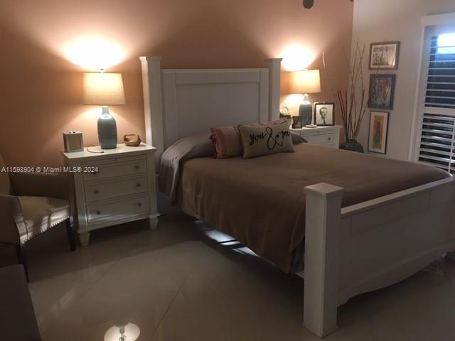 6783 Bridlewood Court, Unit 6783 Boca Raton, FL 33433 - Photo 30 of 56 a bed room with a bed and a night stand