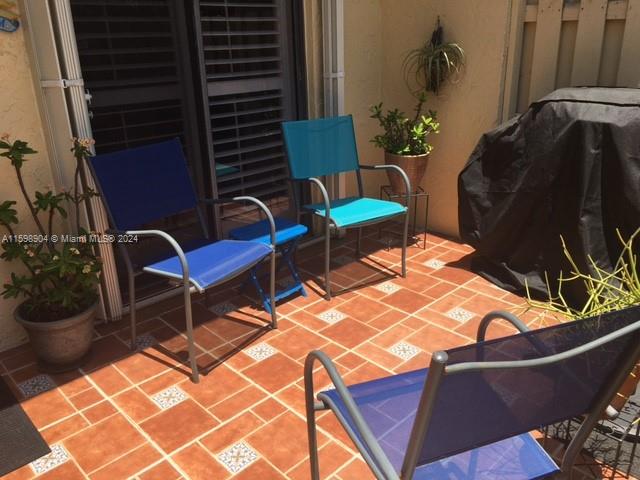6783 Bridlewood Court, Unit 6783 Boca Raton, FL 33433 - Photo 3 of 56 a blue chair sitting in a backyard of a house