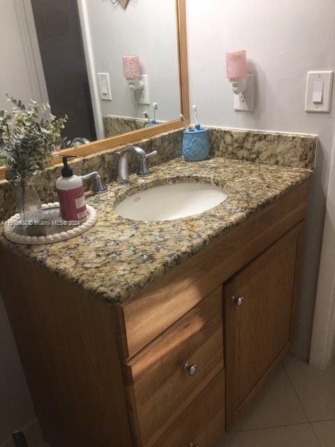 6783 Bridlewood Court, Unit 6783 Boca Raton, FL 33433 - Photo 32 of 56 a bathroom with a granite countertop sink and a mirror
