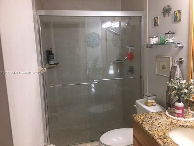 6783 Bridlewood Court, Unit 6783 Boca Raton, FL 33433 - Photo 33 of 56 a bathroom with a granite countertop shower a toilet and a sink