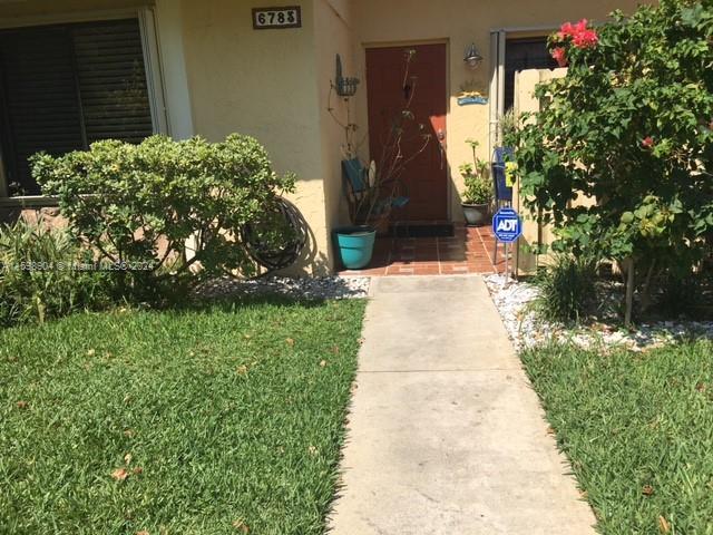 6783 Bridlewood Court, Unit 6783 Boca Raton, FL 33433 - Photo 52 of 56 a pathway of a house with a yard