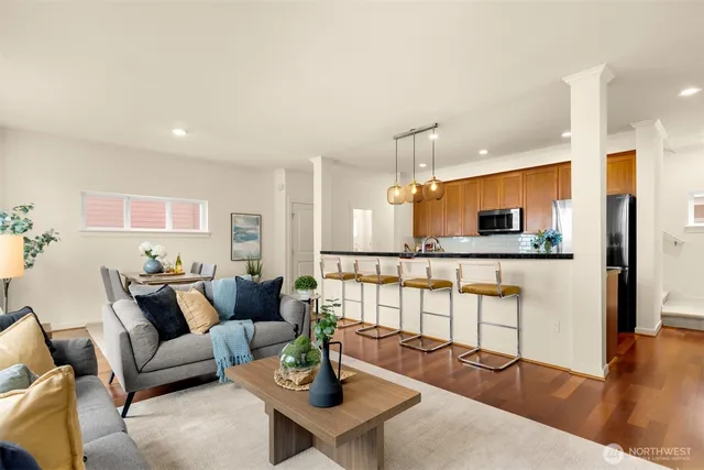 a living room with furniture and a wooden floor