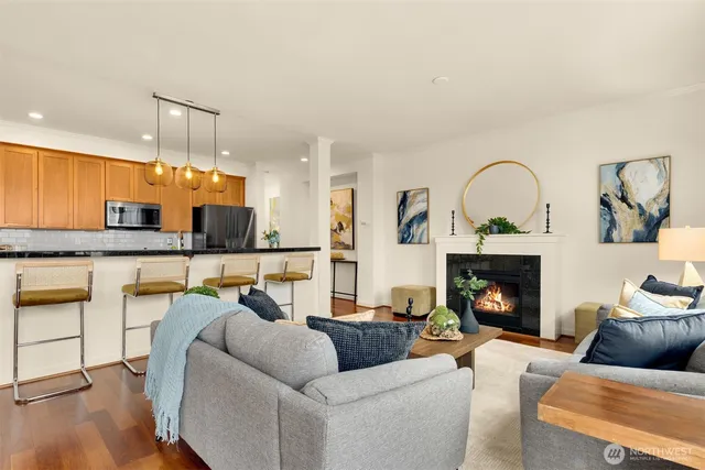 a living room with furniture and kitchen view