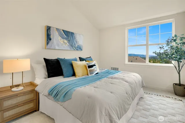 a bedroom with a bed and a lamp