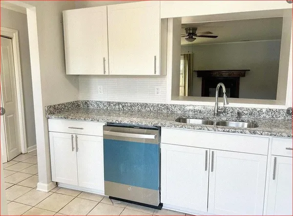 a kitchen with cabinets a sink and stainless steel appliances