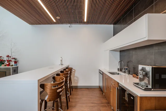 a kitchen with stainless steel appliances cabinets and wooden floor
