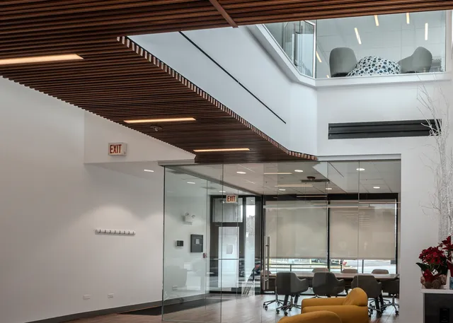 a view of living room with furniture and large windows