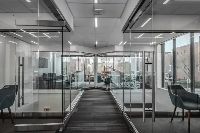 a room with lots of wooden furniture and glass door