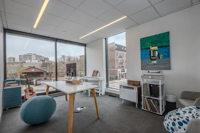 a dining room with furniture and a large window