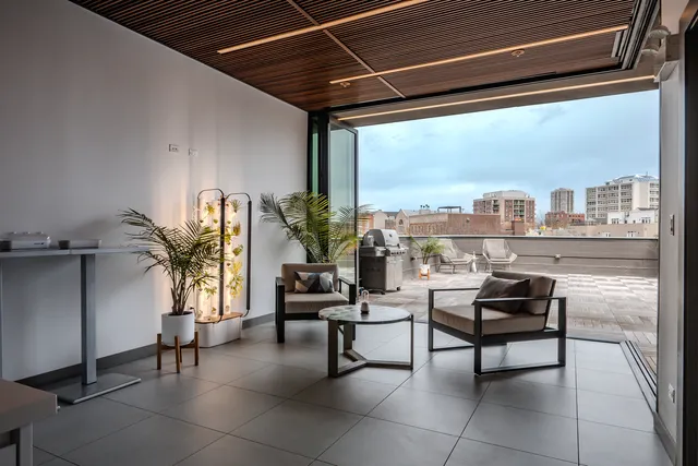 a living room with furniture and a floor to ceiling window