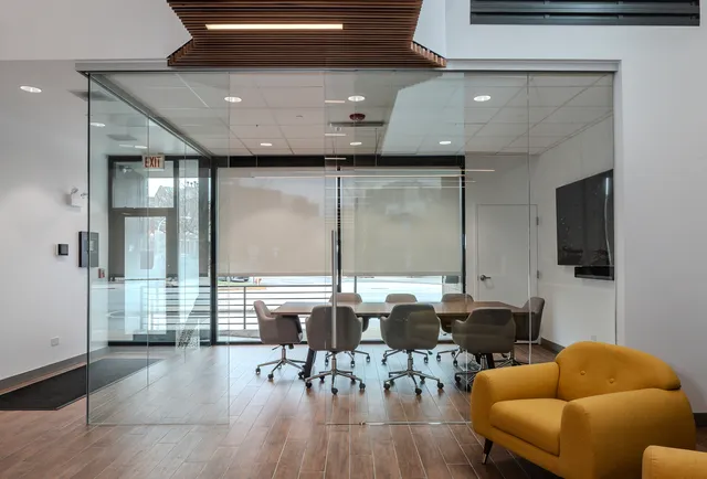 a living room with furniture a flat screen tv and kitchen view