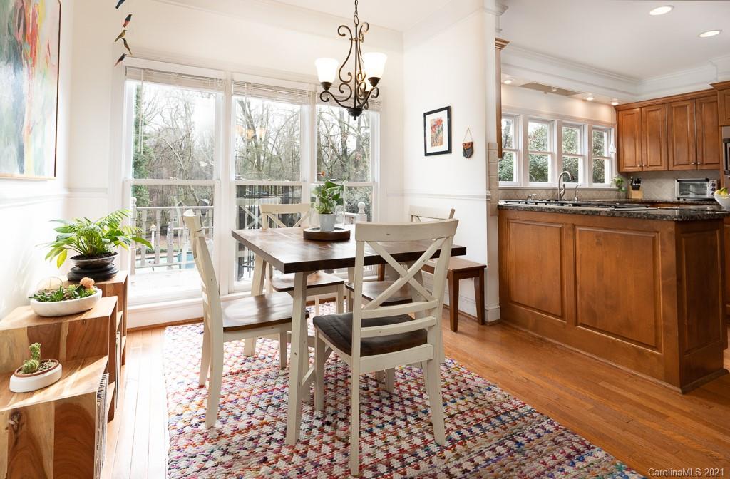 6724 Alexander Road Charlotte, NC 28270 - Photo 10 of 28 a dining room with furniture a chandelier and wooden floor