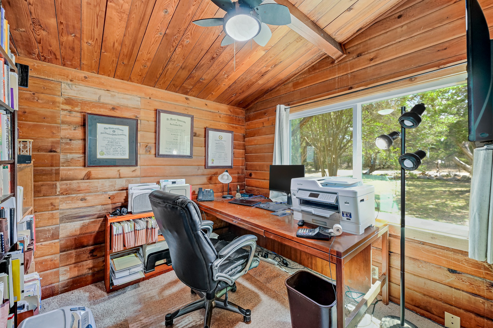 900 Box Canyon Road Wimberley, TX 78676 - Photo 17 of 40 Front office space featuring wooden walls, lofted ceiling with beams, wood ceiling, a ceiling fan, and carpeted floors.