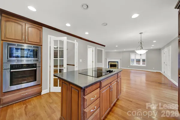 a kitchen with stainless steel appliances granite countertop a sink and stove top oven