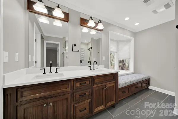 a spacious bathroom with a double vanity sink and a mirror