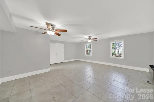 a view of an empty room with a ceiling fan