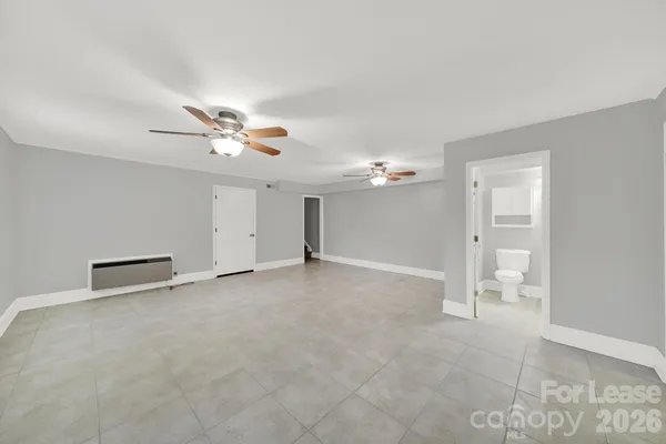 a view of an empty room with a ceiling fan