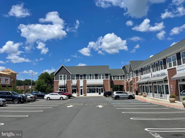 a city street lined with parked cars and buildings