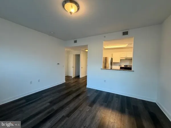 a view of a room with wooden floor and window