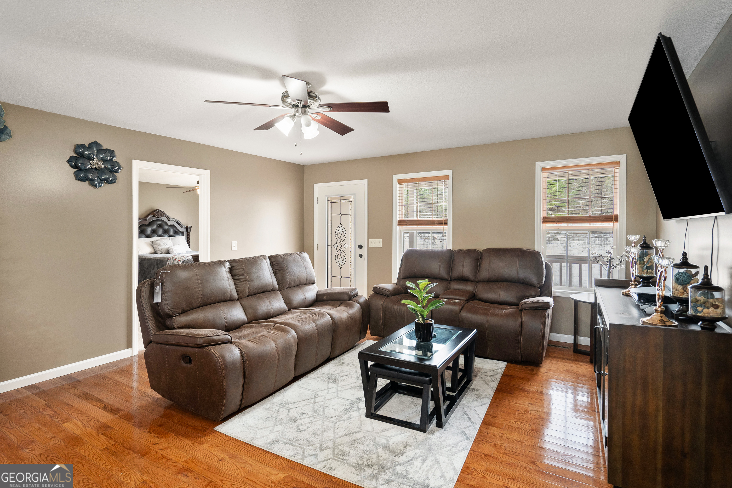 80 Columbus Street Chatsworth, GA 30705 - Photo 11 of 40 a living room with furniture a flat screen tv and a window