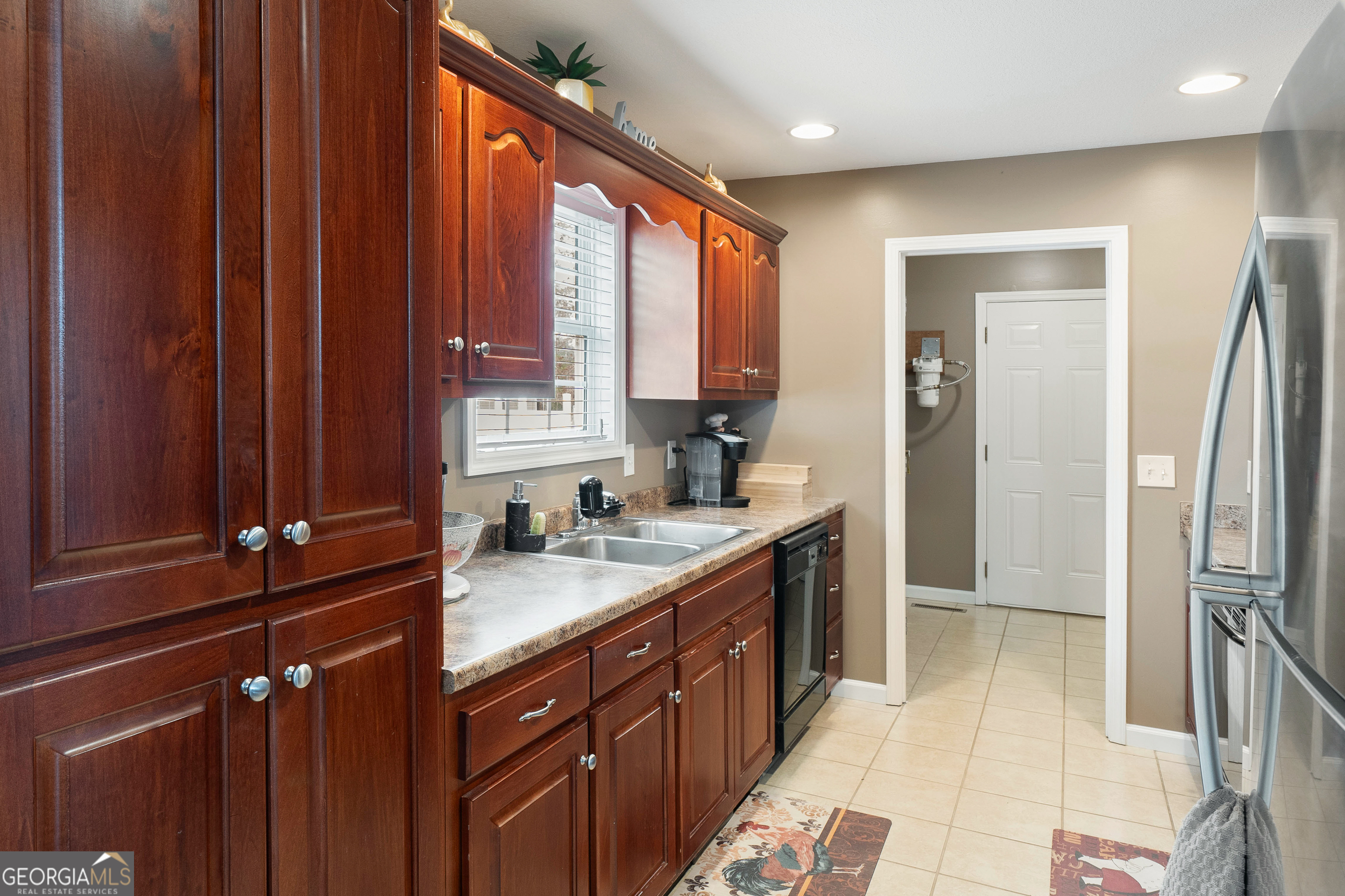 80 Columbus Street Chatsworth, GA 30705 - Photo 16 of 40 a kitchen with a sink a refrigerator and window