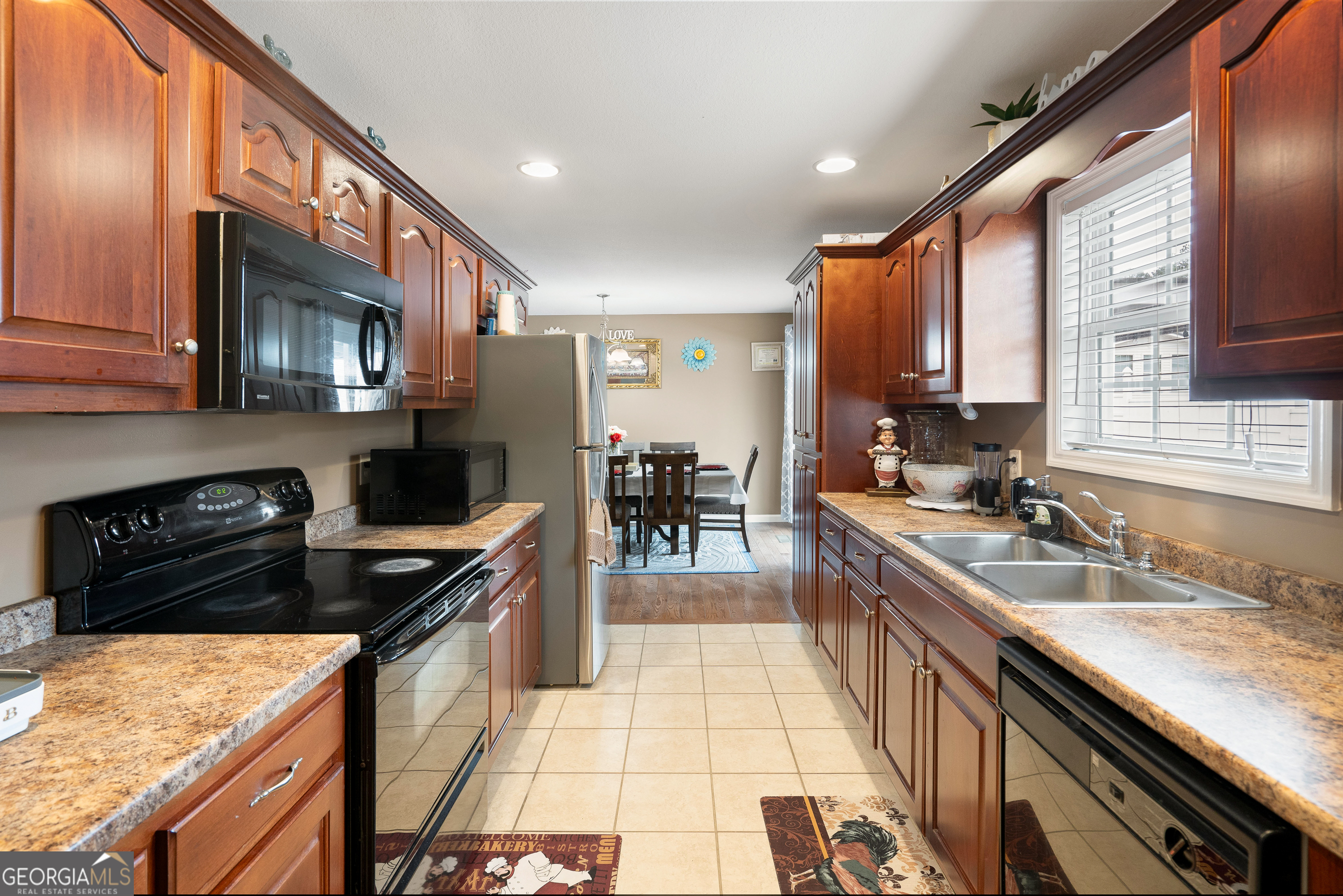 80 Columbus Street Chatsworth, GA 30705 - Photo 18 of 40 a kitchen with stainless steel appliances granite countertop sink stove top oven and cabinets