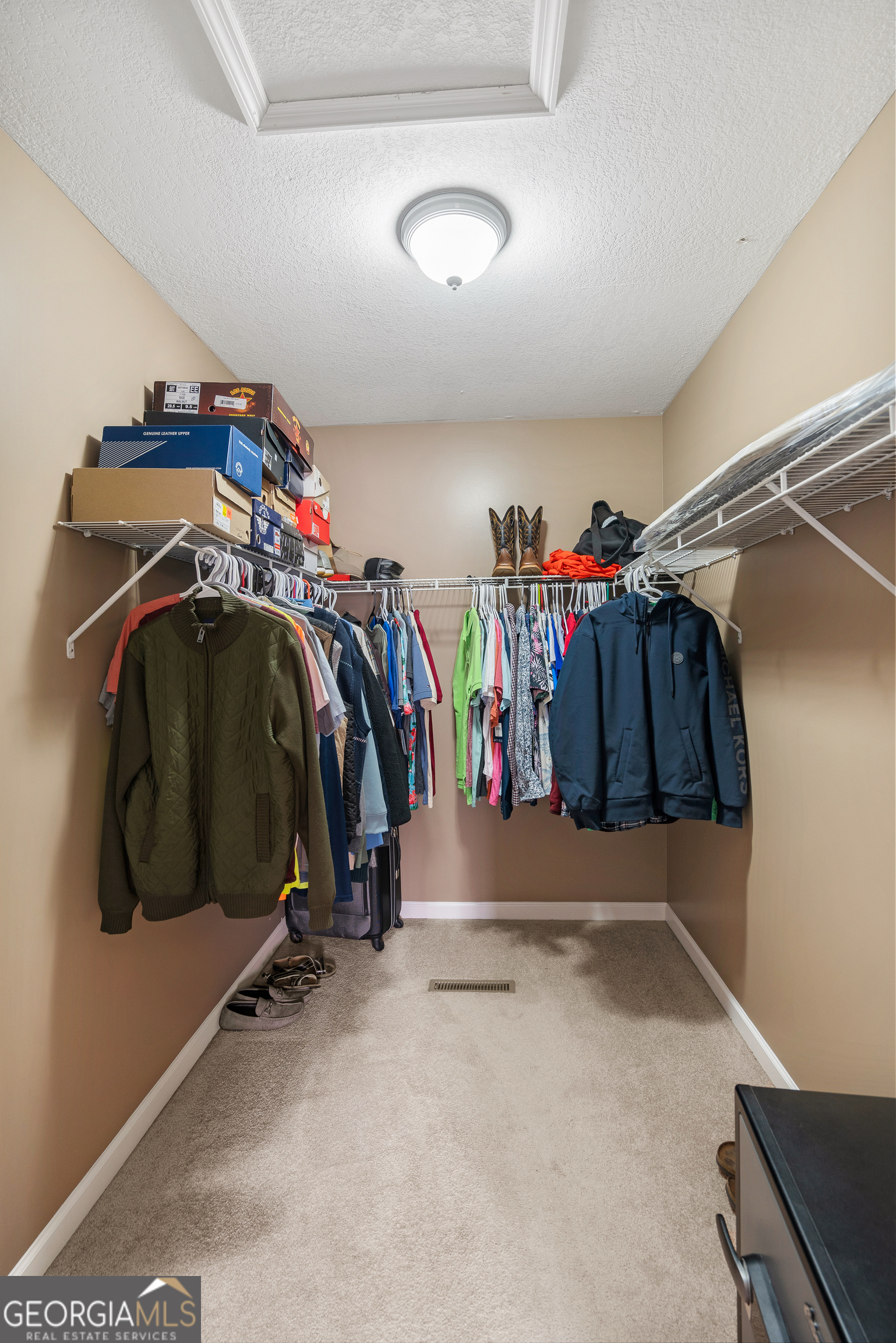 80 Columbus Street Chatsworth, GA 30705 - Photo 25 of 40 a view of walk in closet with clothes and shoes