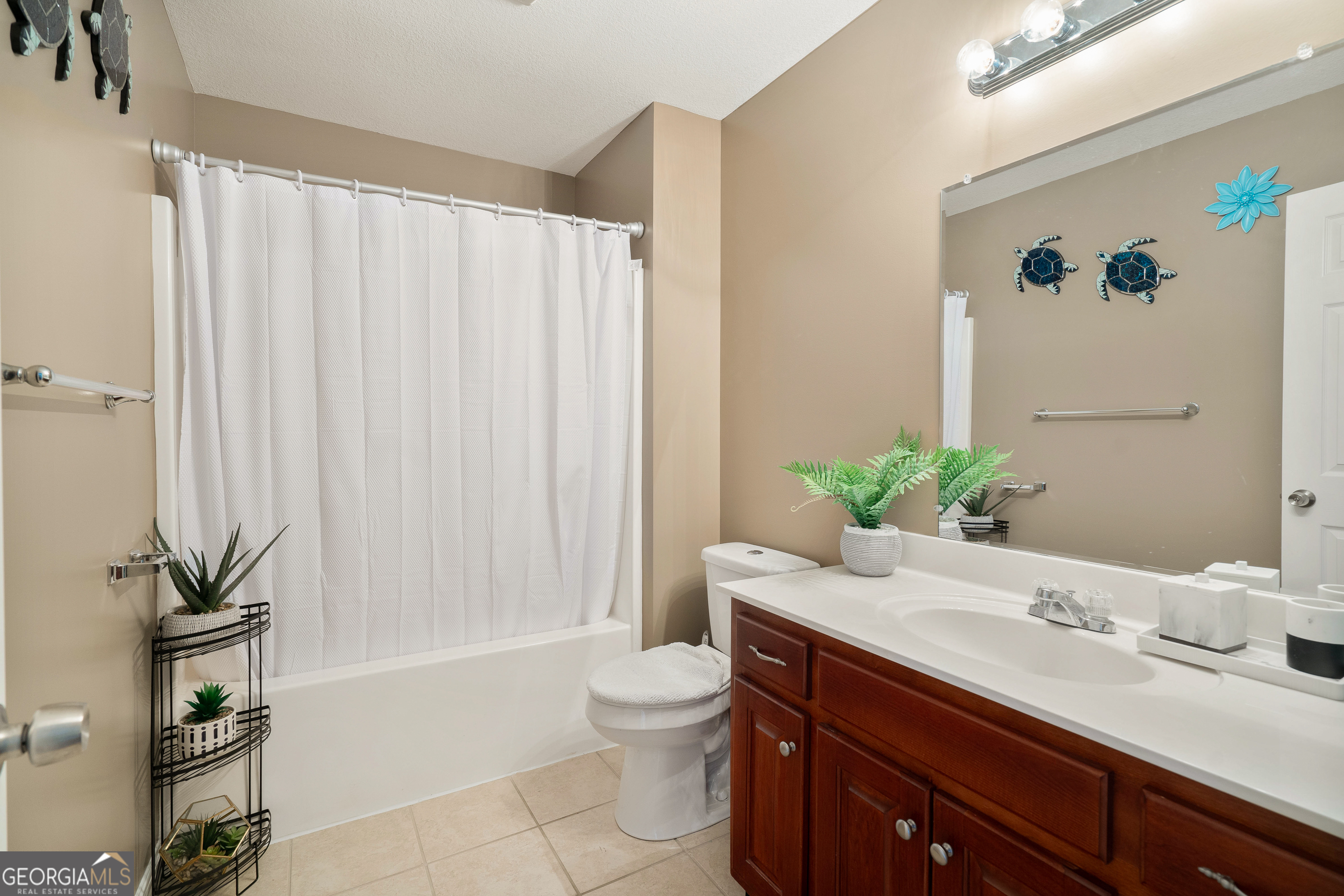 80 Columbus Street Chatsworth, GA 30705 - Photo 29 of 40 a bathroom with a granite countertop sink a toilet and tub
