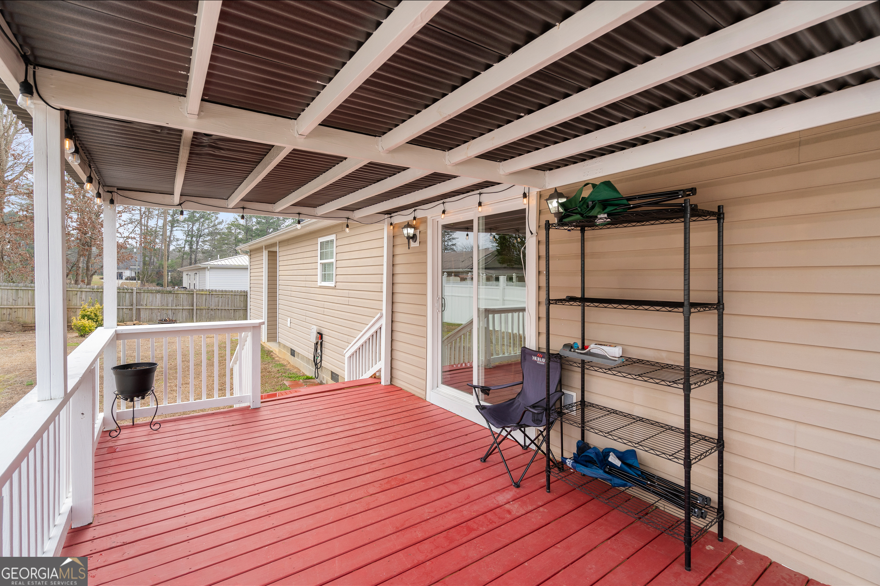 80 Columbus Street Chatsworth, GA 30705 - Photo 33 of 40 a bedroom with a bed wooden floor and glass door