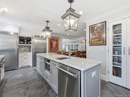 a kitchen with stainless steel appliances a stove a refrigerator and a refrigerator