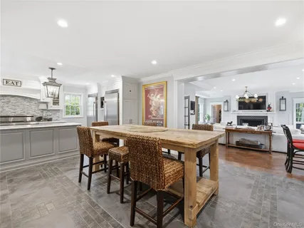 a kitchen with kitchen island a table and chairs in it