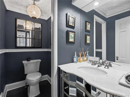 a bathroom with a sink a toilet and a mirror