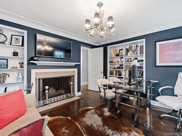 a living room with furniture a flat screen tv and kitchen view