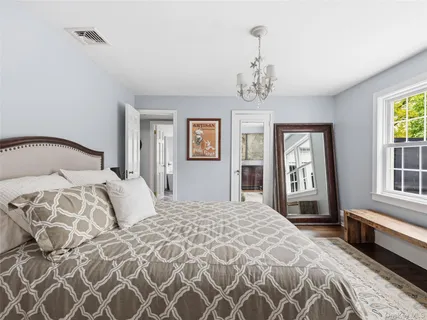 a bedroom with a large bed and a window