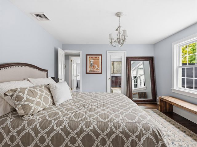 a bedroom with a large bed and a window