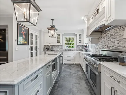 a kitchen with stainless steel appliances granite countertop a stove and a sink