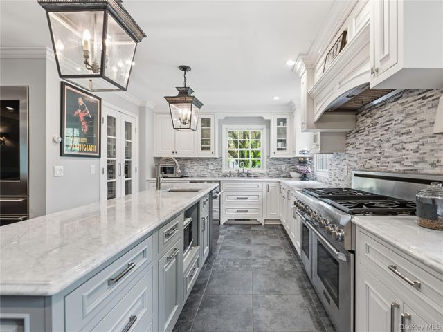 a kitchen with stainless steel appliances granite countertop a stove and a sink