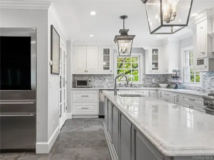 a kitchen with stainless steel appliances granite countertop a sink and cabinets