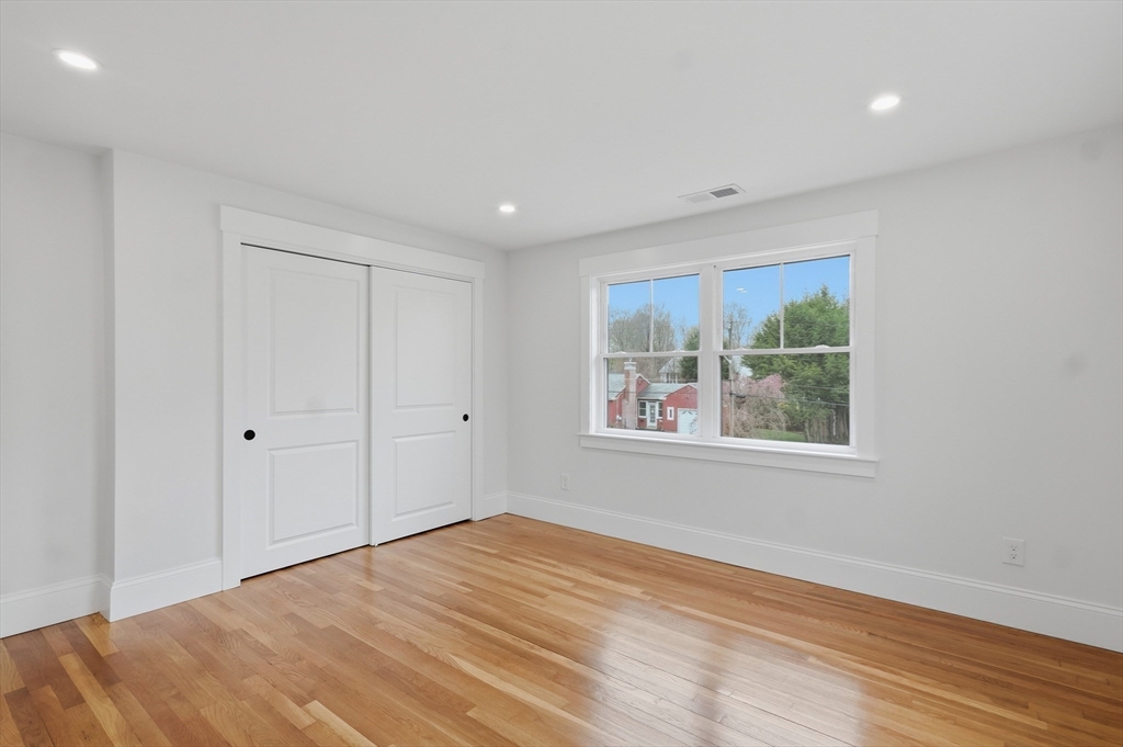 105 Stafford Road Lowell, MA 01852 - Photo 23 of 42 a view of empty room with wooden floor and fan