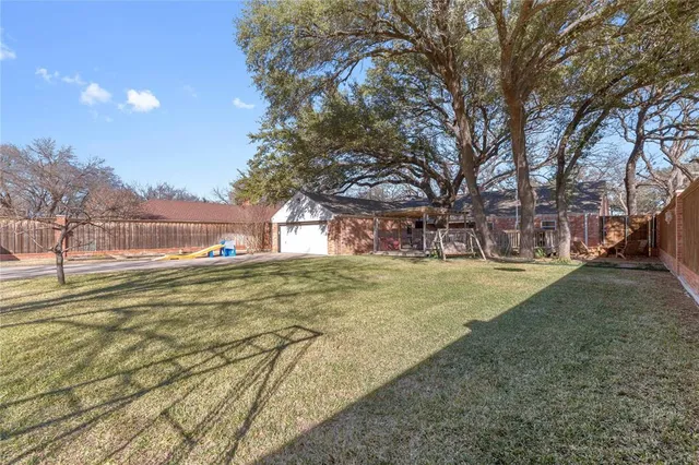 a view of yard with swimming pool and trees