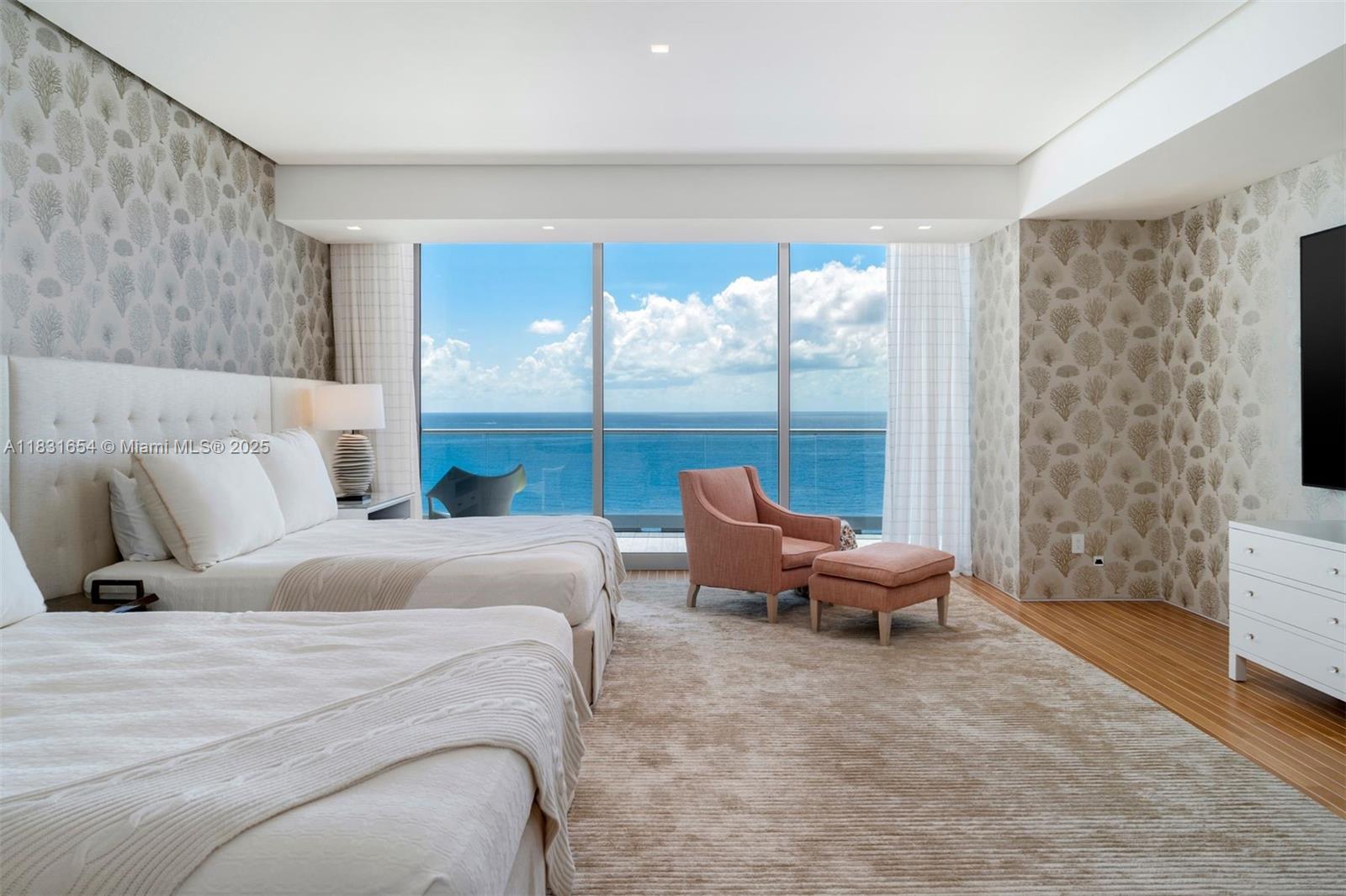 9349 Collins Avenue, Unit 1101 Surfside, FL 33154 - Photo 15 of 37 a bedroom with a bed and large windows