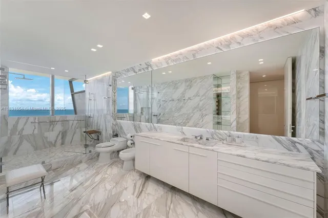 a bathroom with a double vanity sink a mirror and a bathtub