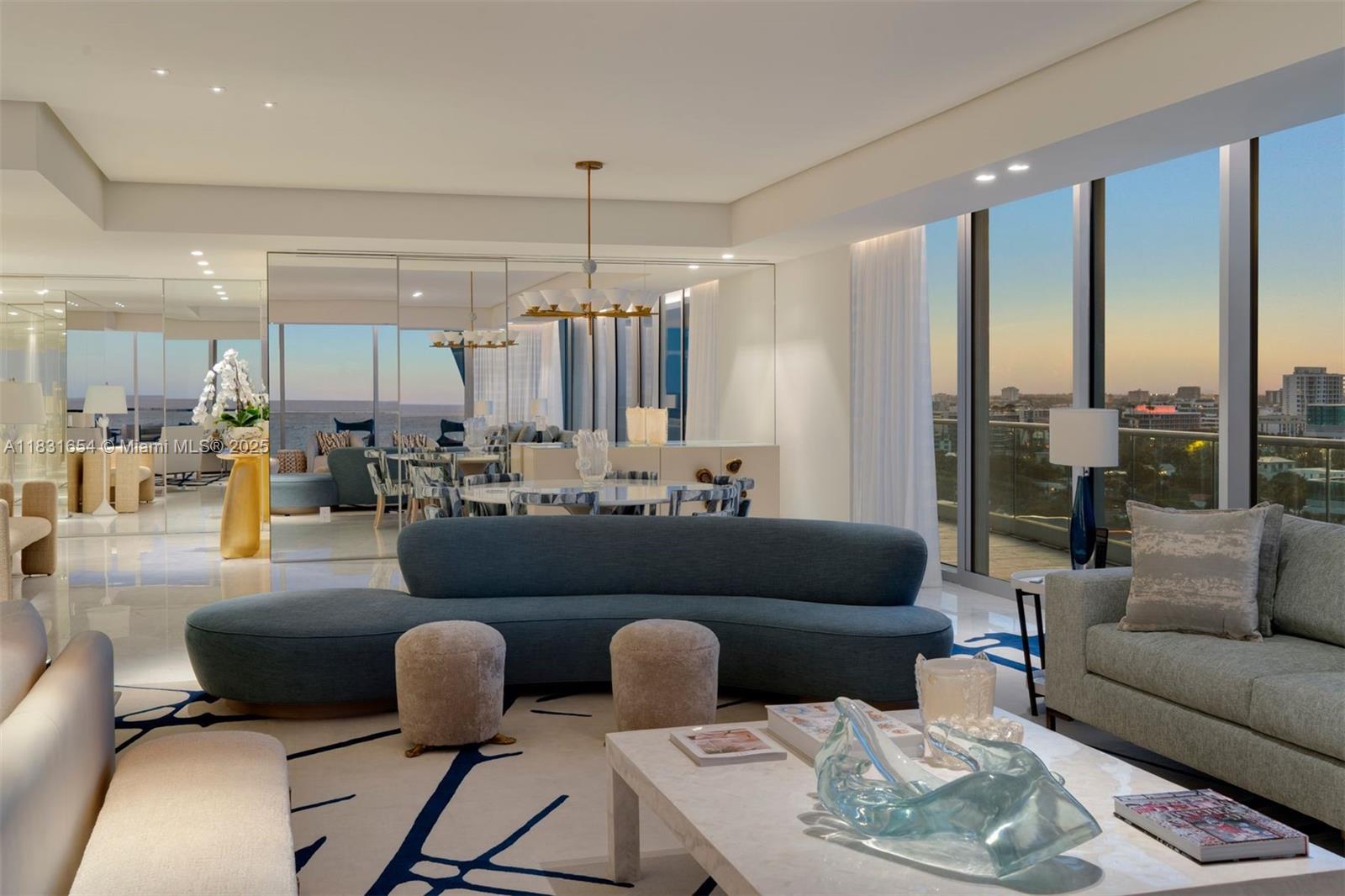 9349 Collins Avenue, Unit 1101 Surfside, FL 33154 - Photo 23 of 37 a living room with furniture kitchen view and a chandelier