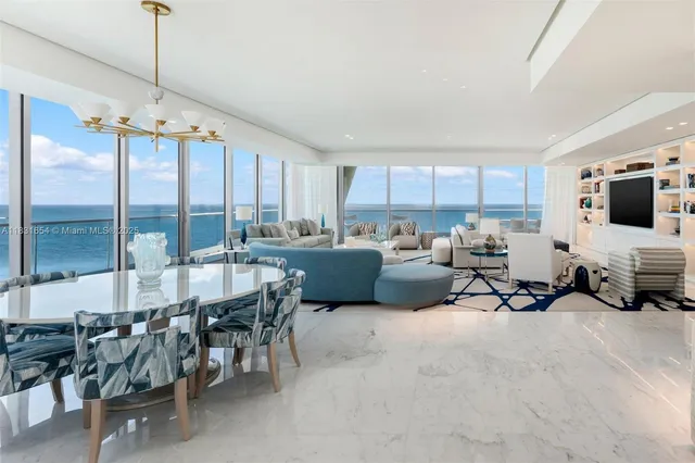 a living room with furniture a window and a flat screen tv