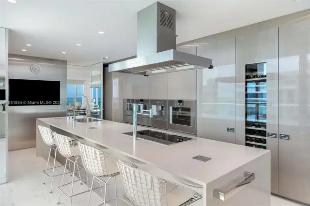 a large kitchen with a table and chairs