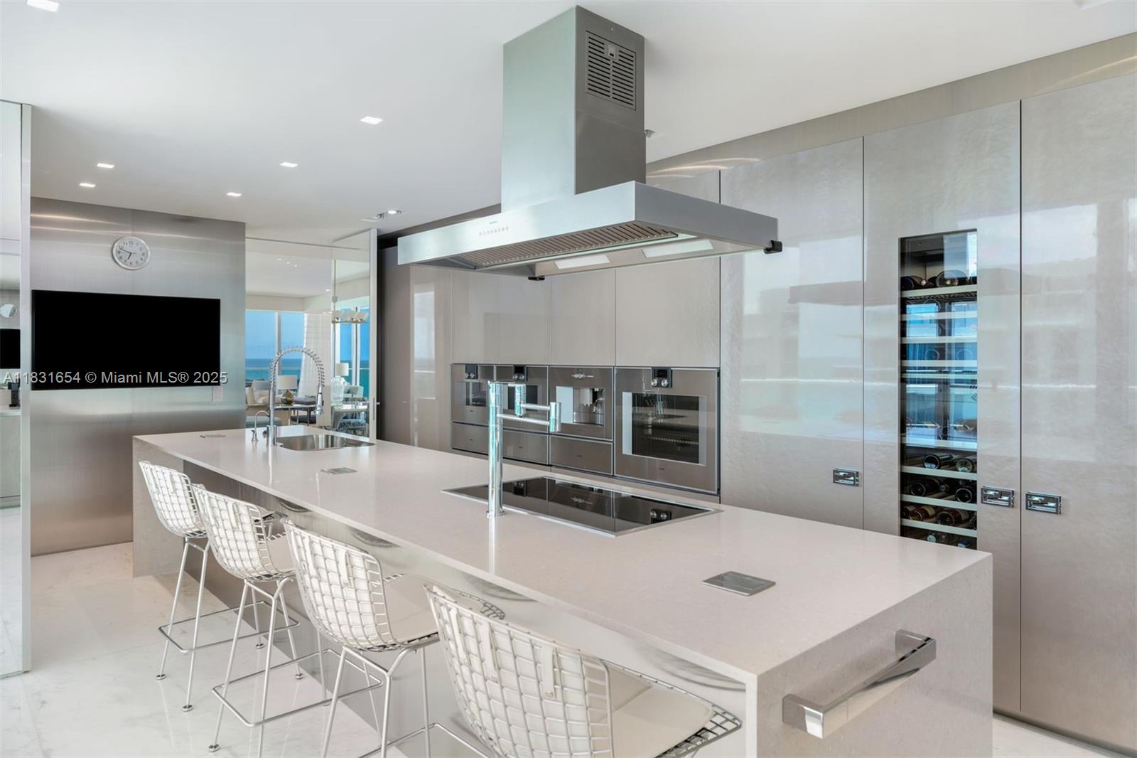 9349 Collins Avenue, Unit 1101 Surfside, FL 33154 - Photo 7 of 37 a large kitchen with a table and chairs