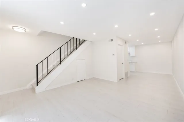 a view of an empty room with stairs